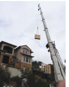 A Crane lifts the giant screen into the home.