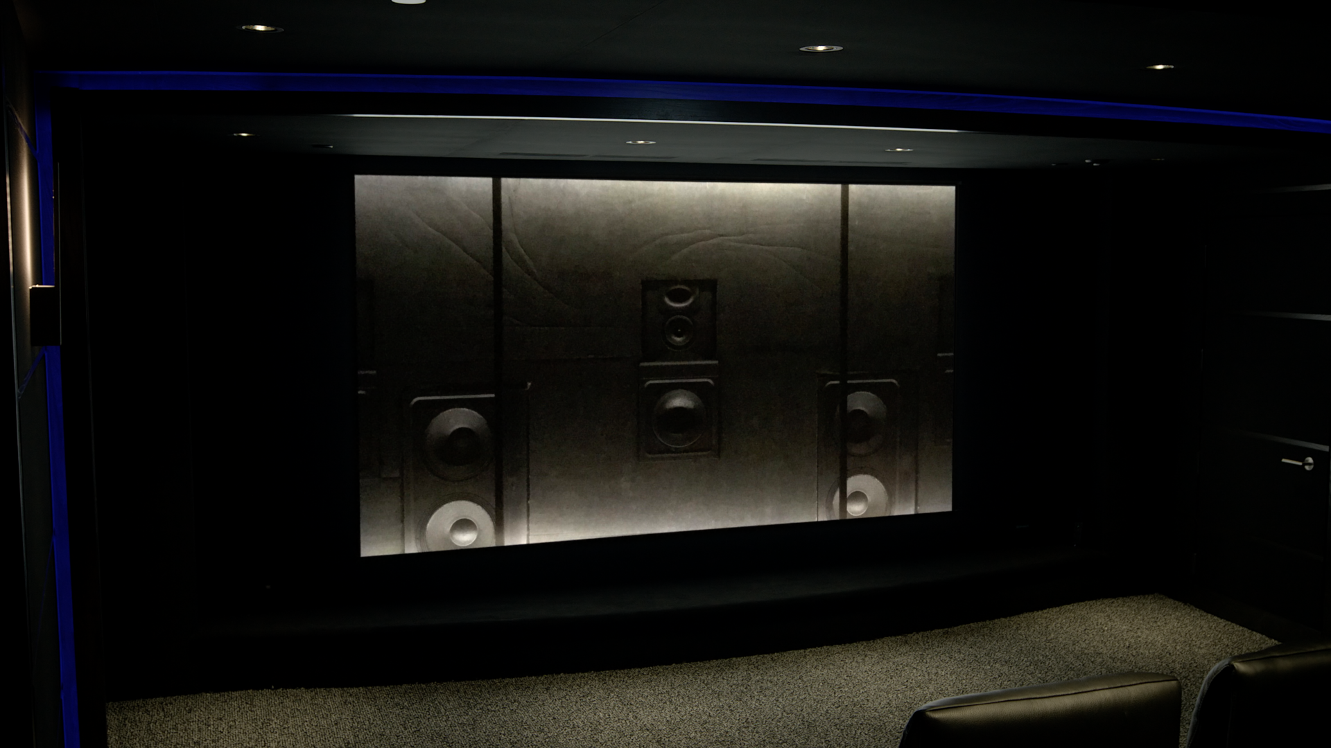 Perforated screen showing speakers behind